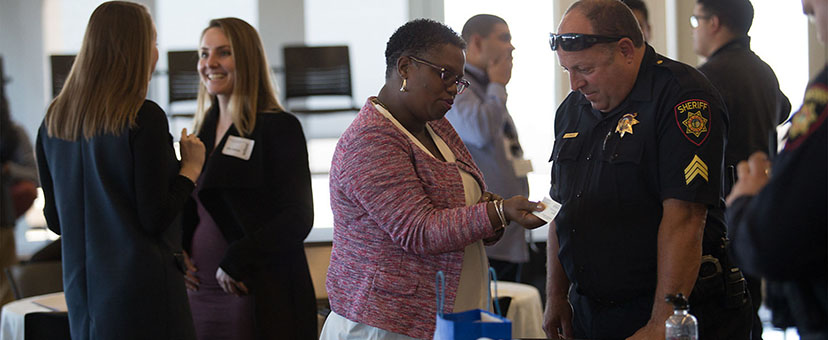 Woman speaks with police officer at event Woman speaks with police officer at event