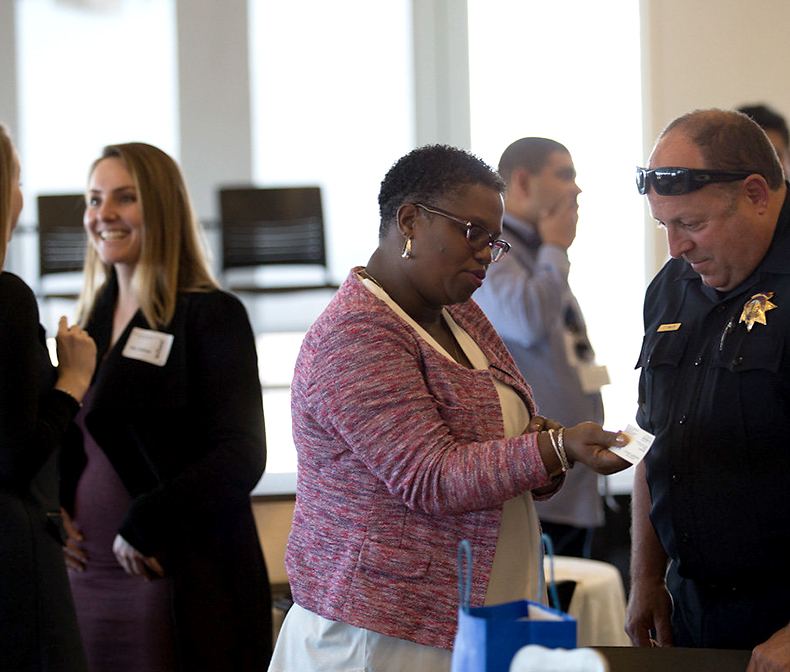 Woman speaks with police officer at event