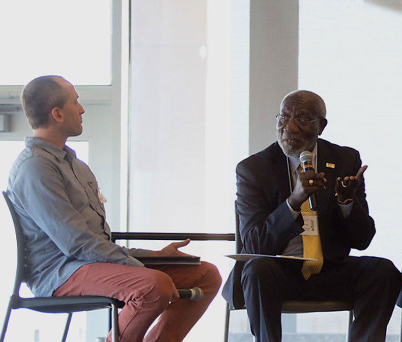 People speaking on a panel